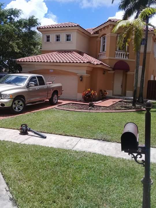 Rojo's Lawn Service crew maintaining a Miami property